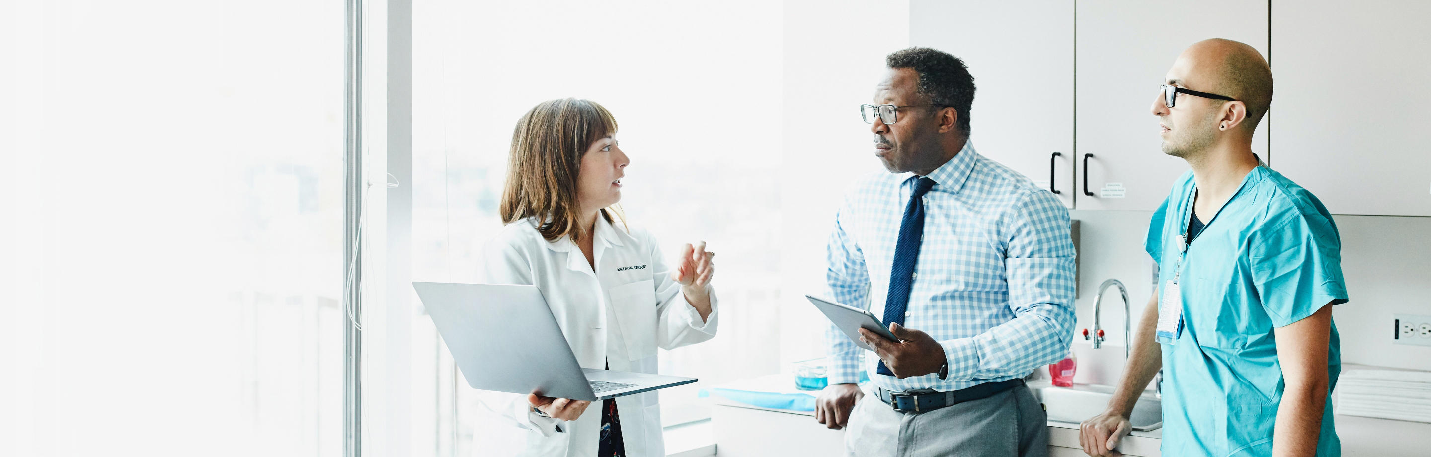 three healthcare professionals talking to each other