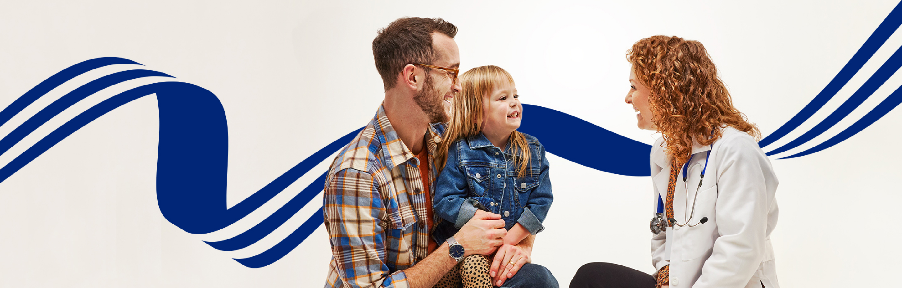 man holding child speaking to a female provider