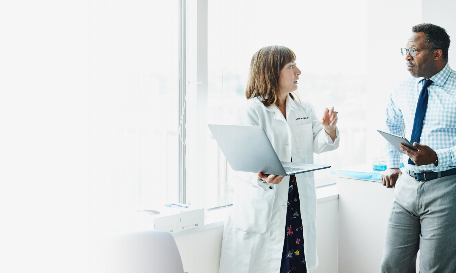 three healthcare professionals talking to each other