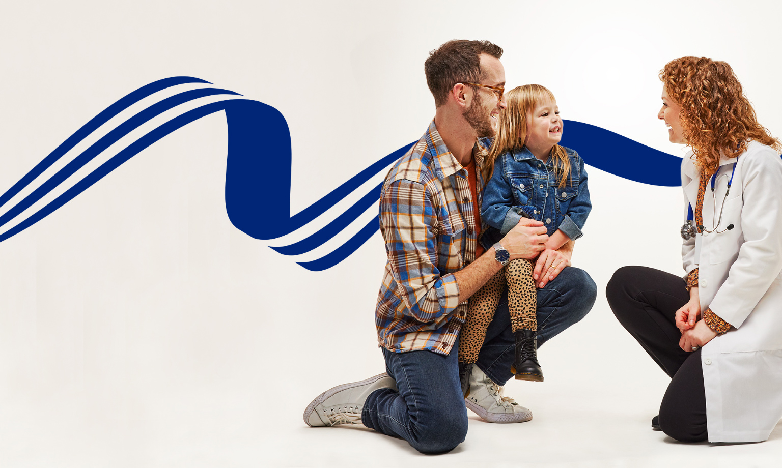 man holding child speaking to a female provider