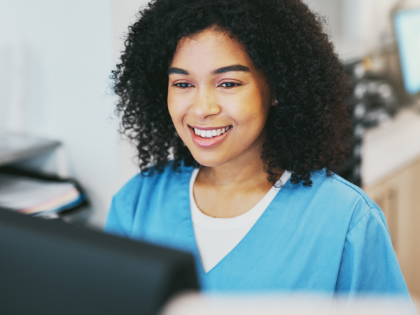 Smiling provider look at a computer monitor