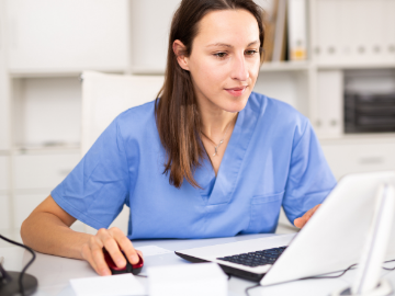 female provider looknig at a computer screen