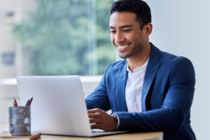 Smiling man looking at a computer